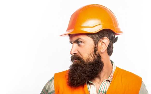 Free Photo | Male builder in uniform showing arm muscle and smiling and  looking strong, front view.